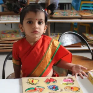 ahmedabad-montessori-cultural-day-fruit-puzzle-activity-girl