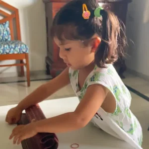 ams-practical-life-child-doing-carpet-mat-rolling-activity