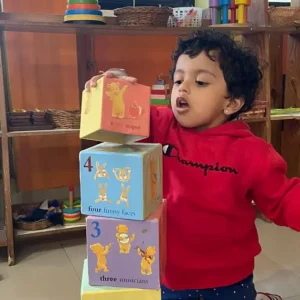 toddler-stacking-large-number-blocks-learning-counting-ams